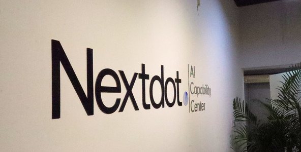 Nextdot AI Capability Center signage on the office wall